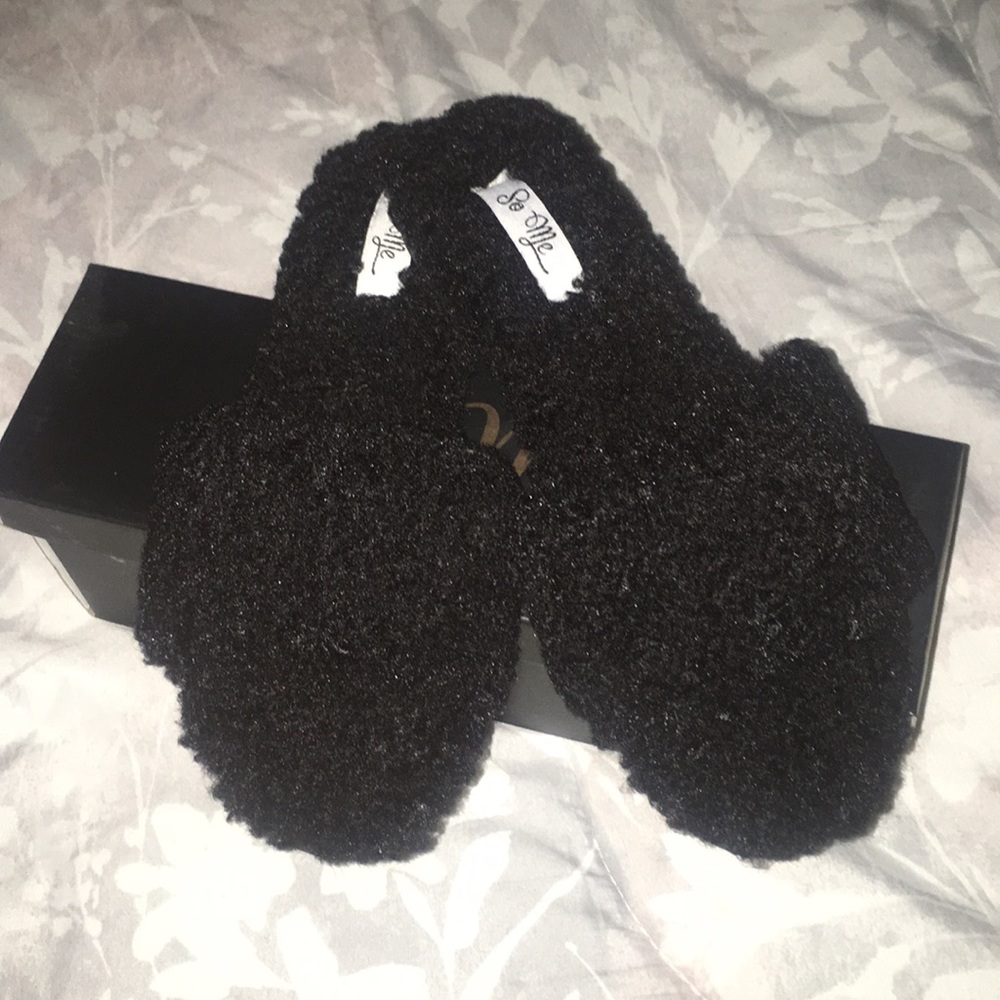 Fluffy black slippers.